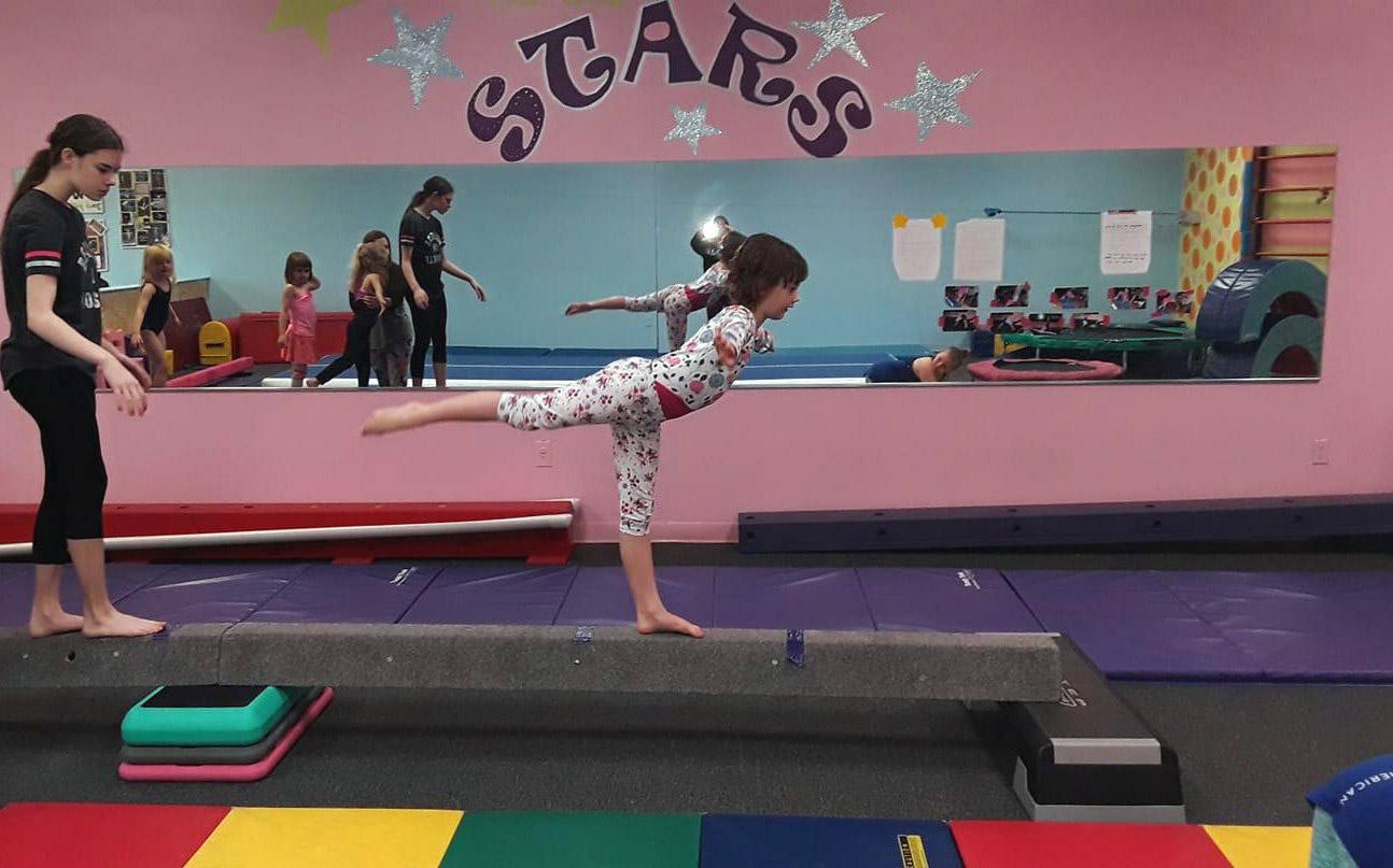 gymnast doing a backward scale